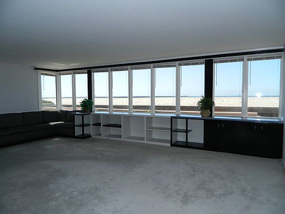 Downstairs living room with windows the full length of the r