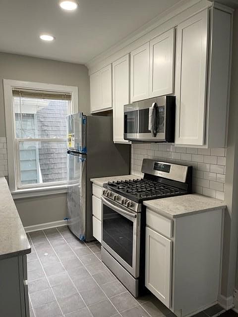 Gas oven, garbage disposal, microwave - hardware on cabinets will be installed