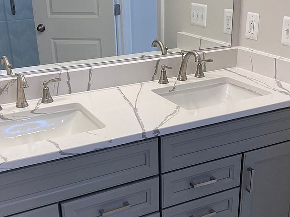 Owner s bathroom with dual sink, gray cabinet vanity at a DRB Homes Newbury II plan at the Barron He