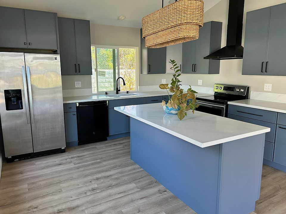 Brand new kitchen with dishwasher, refrigerator, stove, and large center island