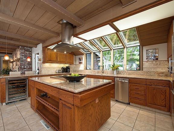 Light filled window in kitchen looks onto neighborhood