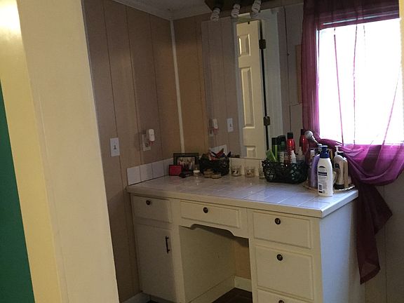 Vanity area beside bathroom