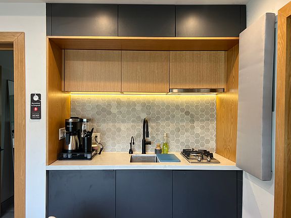 Kitchen with mini-fridge, gas cooktop, instant hot water tap.
Recommend getting an air fryer or small microwave oven. Multiple cabinets for storage.
