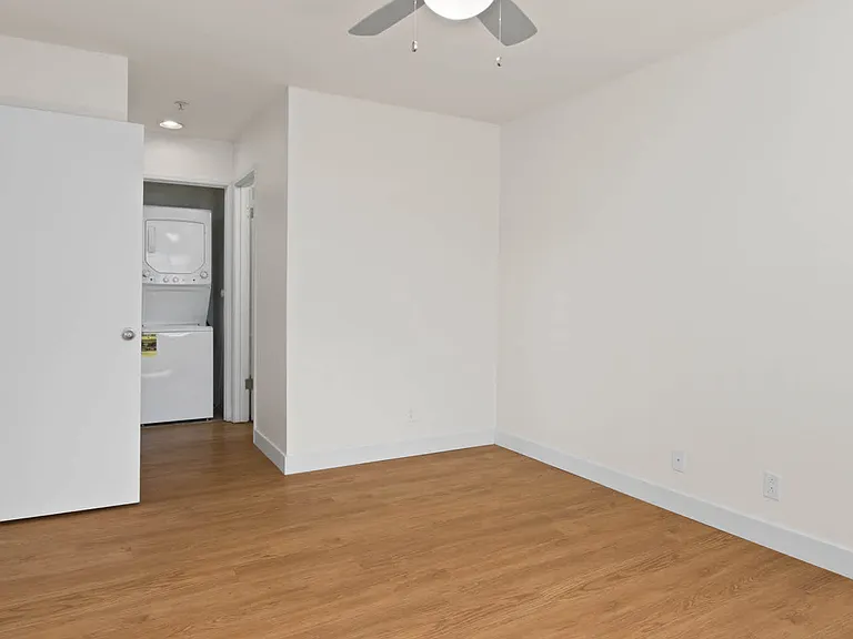 Bedroom with Hard Surface Flooring and In-home Washer and Dryer