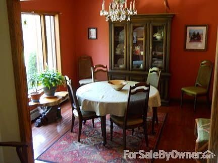 Formal, sunny dining room
						:
						Hardwood oak floor, large window enhances the dining experience- beautiful view