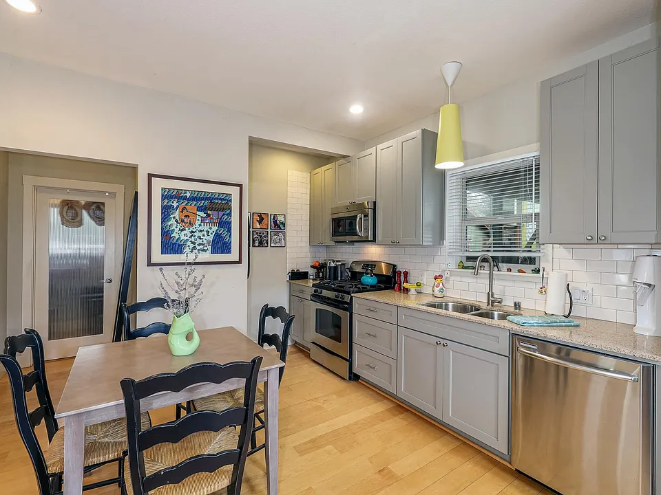 Kitchen and dining area. Gas range, micro hood and dishwasher.