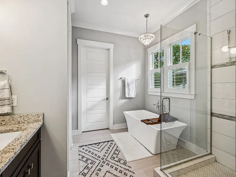 Ensuite bath to primary bedroom. Luxurious spa bath with a tiled shower, soaking tub, double vanities, walk-in closet, and its own laundry area.