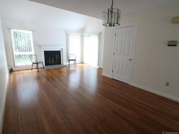 Living room/Dining room combo with fireplace and slider to d
