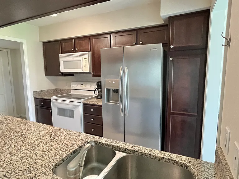 Kitchen which includes fridge includes filtered water and ice maker