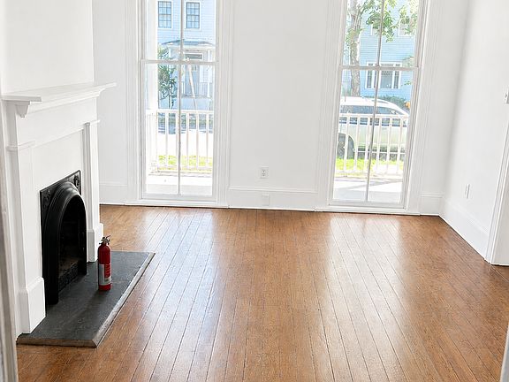 Rendering of front room with fresh white paint and refinished hardwood floors