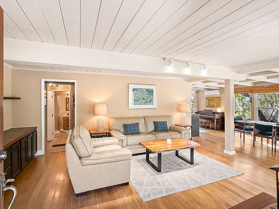 Light and bright entry living room with open layout, wood floors, and abundant natural light.