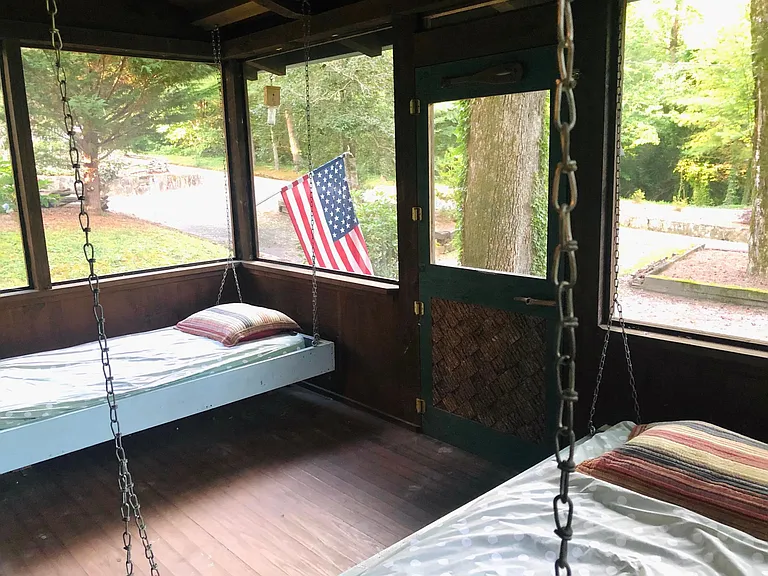 Front sleeping porch with two hanging beds.