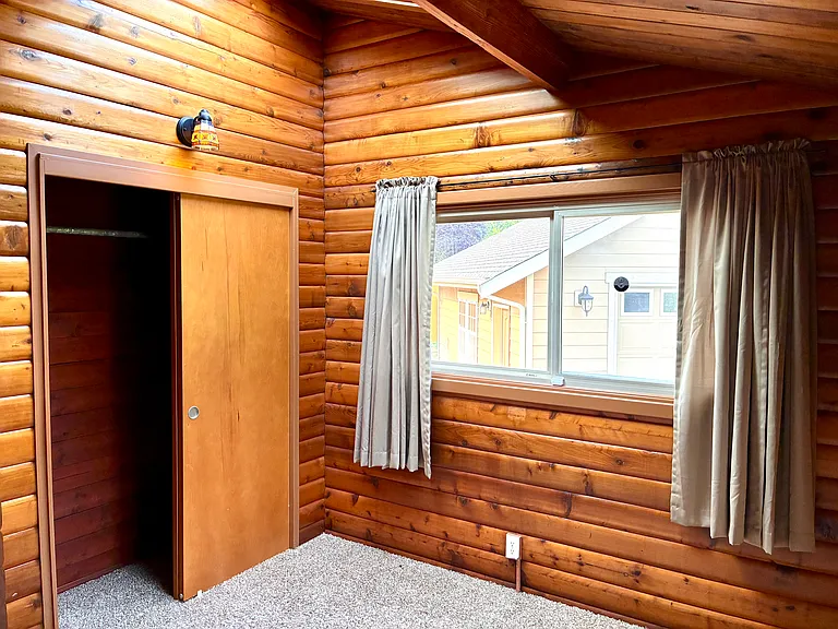 Bedroom One with closet and window, skylight for additional natural light.