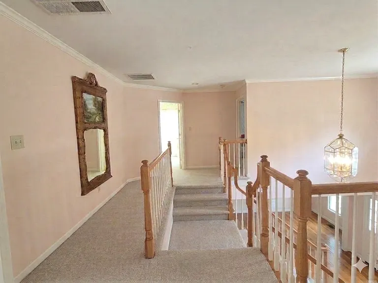 Stairs splits two directions to the second floor hallway to rooms.