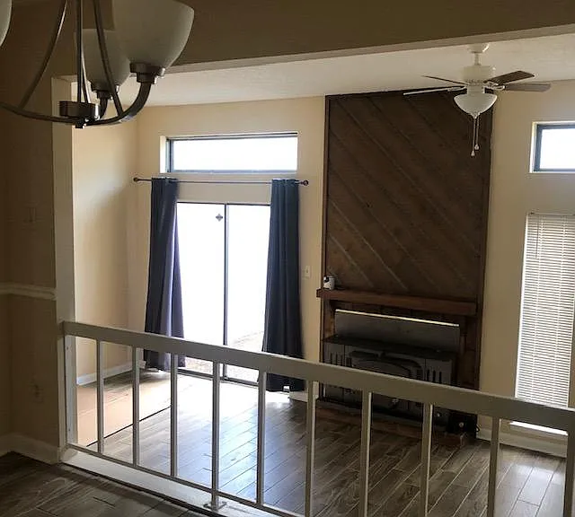 View of living room with fireplace from dining room