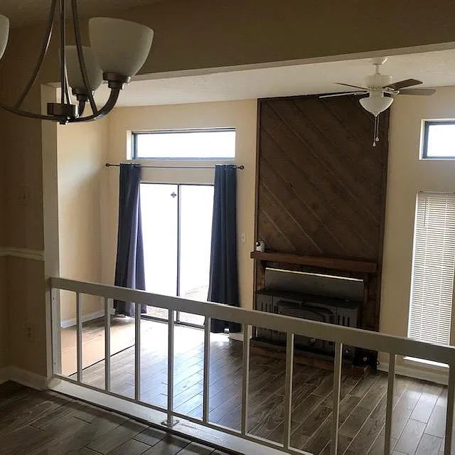 View of living room with fireplace from dining room