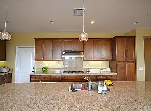 Kitchen with ilsand and granite counter top.