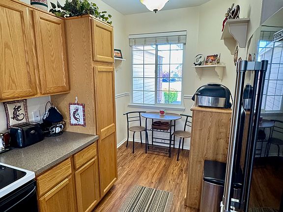 Kitchen with nook and view out window of front porch/parking lot.