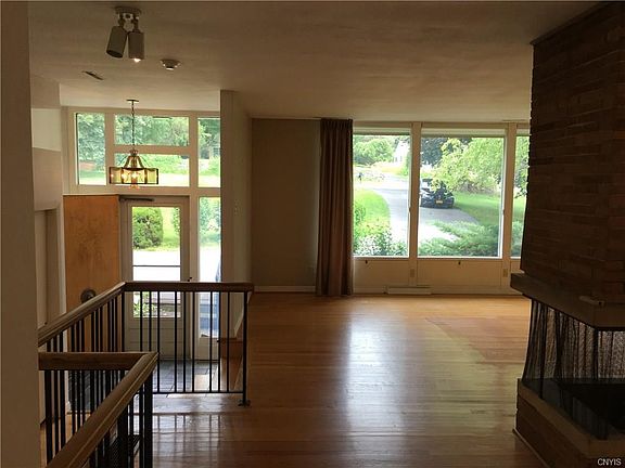 Note hardwood floors throughout main level, with wall to wall windows everywhere.  Home is designed to let the park like setting be enjoyed as much from the interior of home as it will be when you step outside.