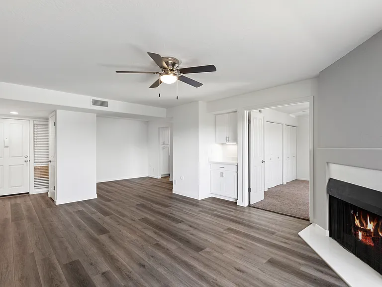 Spacious Living Room with Wood Burning Fireplace with Quartz accents. Vinyl Plank flooring, Dry Bar with additional storage.
