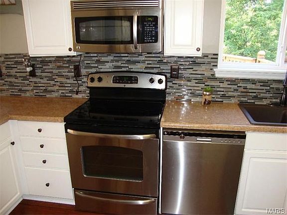 Upgrades stainless appliances and beautiful tile backsplash.