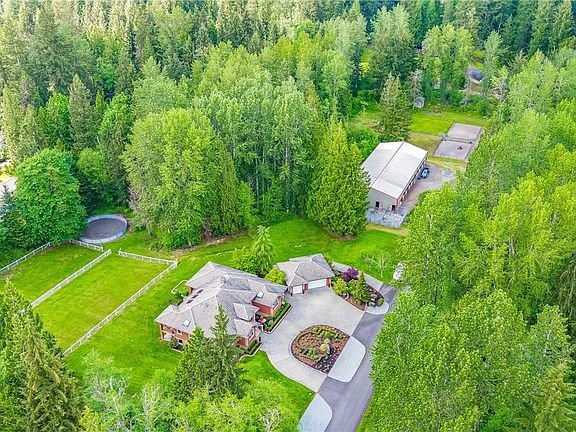 Custom quality equestrian estate featuring a solid brick daylight rambler located down a paved lane in East Woodinville offering a rural setting yet close to shopping, restaurants, Microsoft and Woodinville's Wine/tourist district.  
