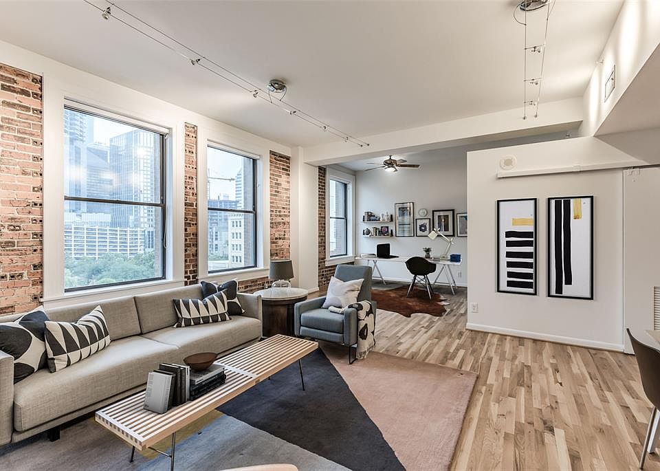 Amazing skyline views from this wonderful loft. Corner unit has exposed brick, hardwood floors. Great floor plan - very lofty & lives much larger than it is. Monthly HOA includes wifi, basic cable, water, sewer, trash, and gas! Open secondary bedroom