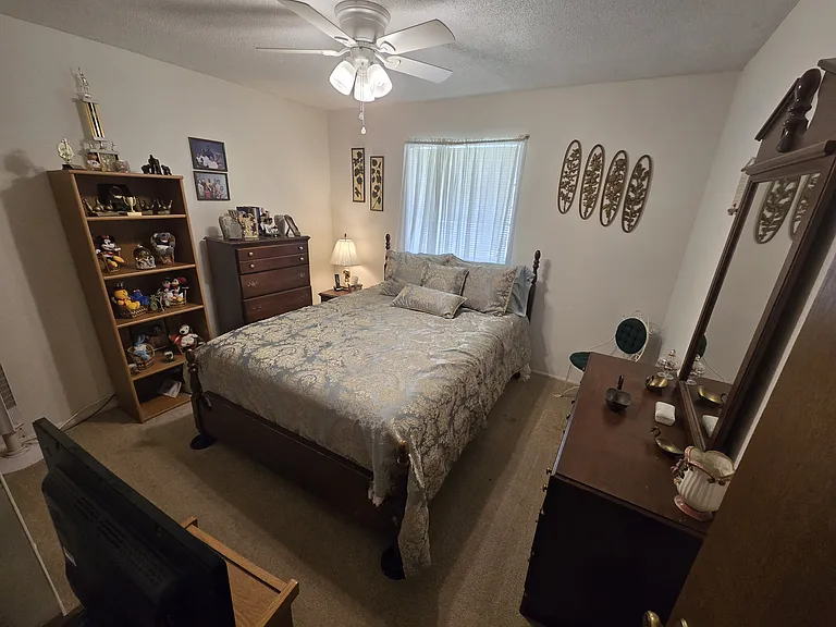Guest bedroom comes with queen-sized bed, dresser, bookshelf, nightstand, bookshelf, chair, and His & Hers closet with two doors.