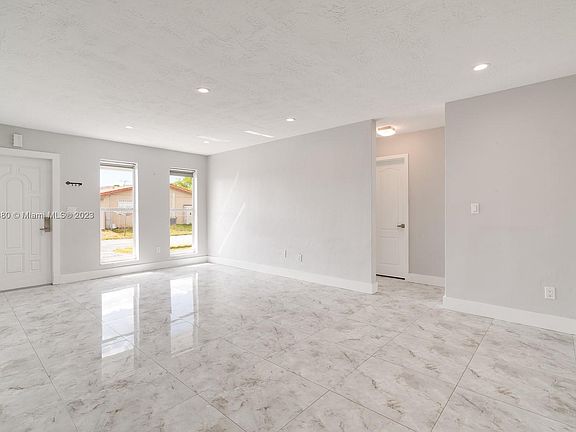This view is from SE corner of the livingroom looking towards the North side of the livingroom and the hallway that leads to the updated Bathroom and the Primary and second Bedroom.