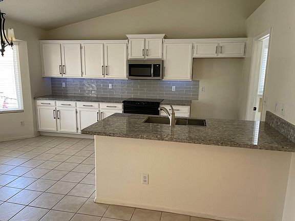 Kitchen with granite and under cabinet lighting - laundry room to the right.