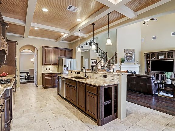Dream kitchen with gorgeous coffered ceiling. Features double ovens, gas cooktop, under cabinet lighting, pot filler, exotic granite and much more!