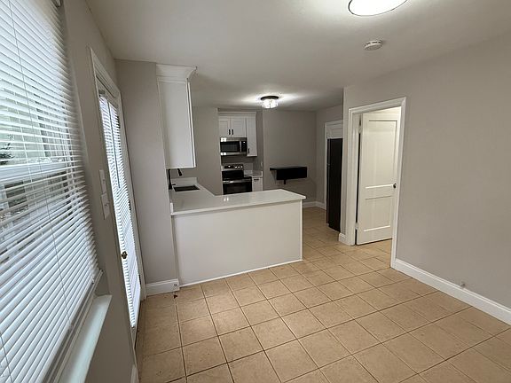 View into kitchen and hallway to bed and bath