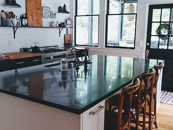 Completely renovated modern kitchen, with 2 sinks, double oven, 6 burner stove and electric griddle. Island with storage and 3 barstool places.