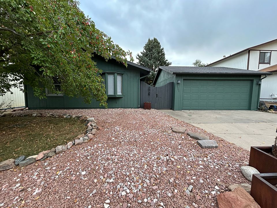 This is the view of the front of the house. A two-car driveway is wide and long enough for a small RV or several cars.