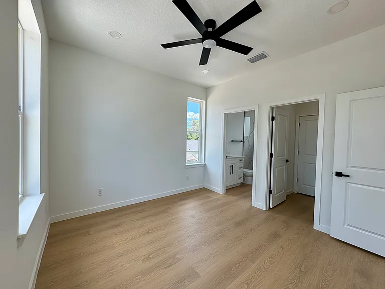 Spacious bedroom with ensuite bathroom and walk-in closet.