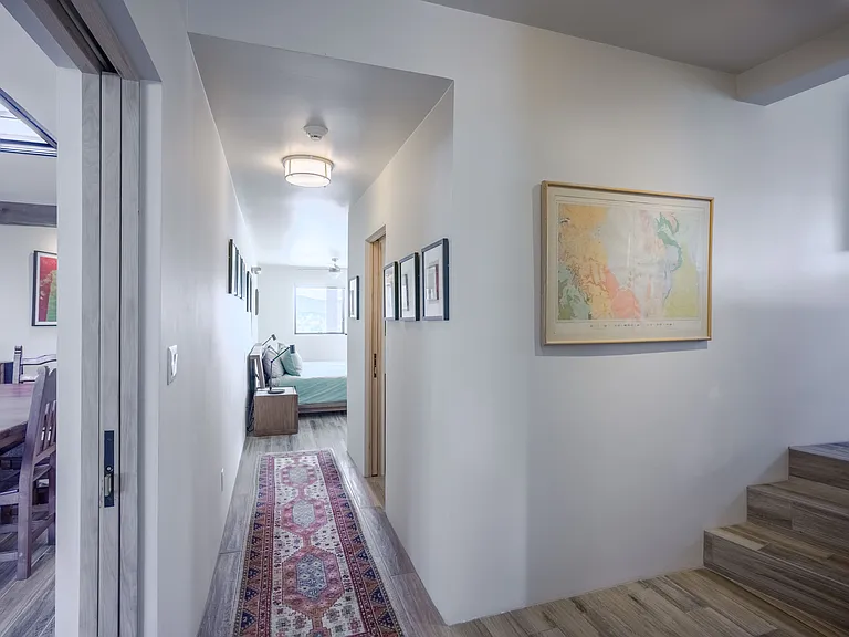 Hallway to the master bedroom, to the right are half flight of stairs to the office