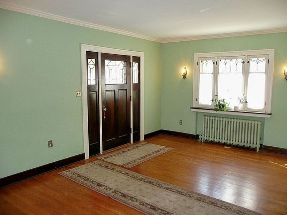 Refinished hardwoods, original moldings and stained glass windows!