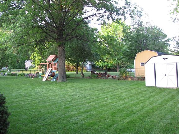 Fenced in backyard with shed