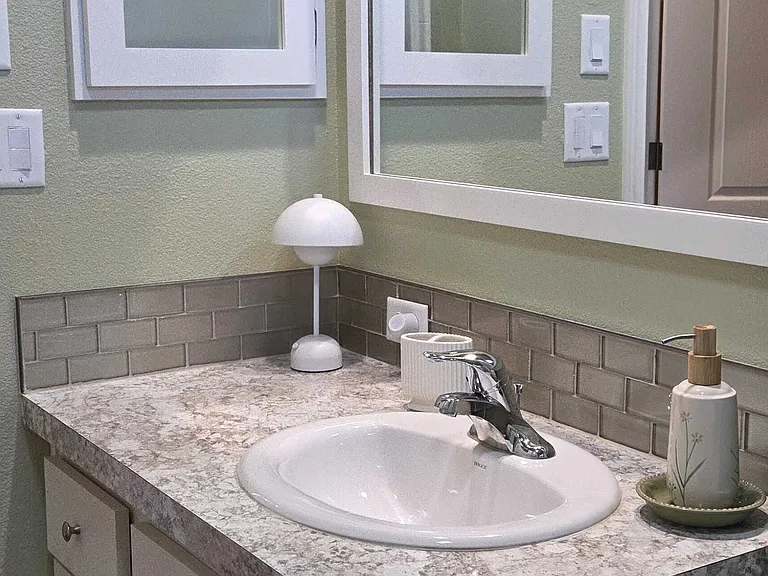 Built-in medicine cabinet with front facing mirror. Bathroom also provides two different light switches controlling multiple lights sources for great lighting.