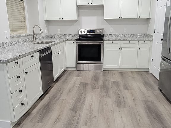 Kitchen. Includes refrigerator, oven/stove range, and a dishwasher