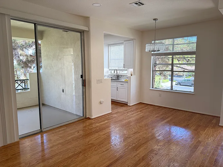 View of patio, kitchen entrance and dining area.