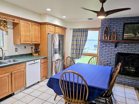 Ceiling fan in dining room overseeing dock.