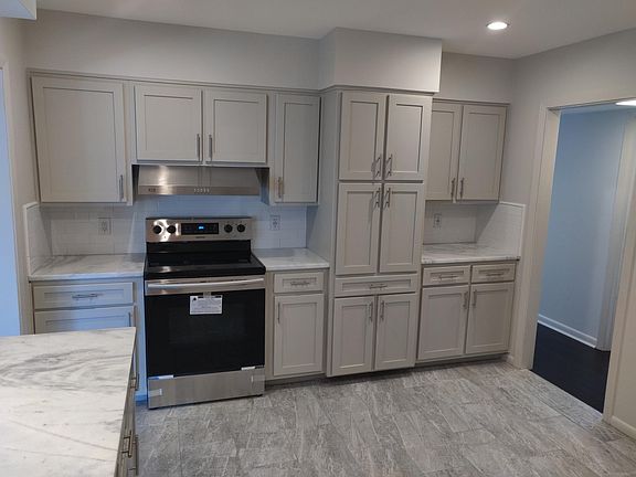 New Range and Hood. Granite Countertops. Soft Close Cabinets. Tile Backsplash. Canned Lights.