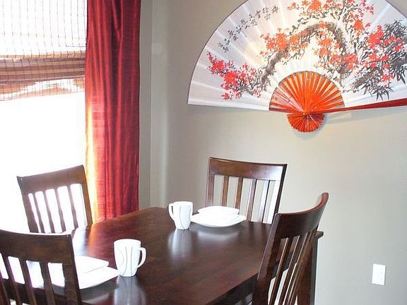 Eat-in kitchen has bay window and wood-look laminate flooring