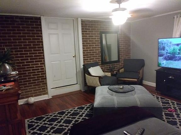 Brick wall accent in Den