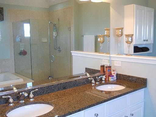 Master bath boasts granite countertops, double sink and separate shower.