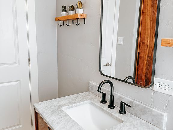 Upstairs bathroom with a full shower and bath, mid-century modern cabinets, and elevated fixtures.