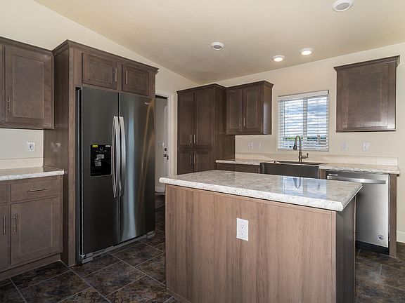 Kitchen - Solid wood cabinets, upgraded stainless appliance package, upgraded nickel hardware, large kitchen island, title back splashes, country farm sink, skylight, recessed lighting.
