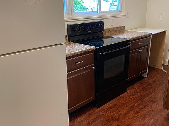 Kitchen with windows looking out to driveway area
