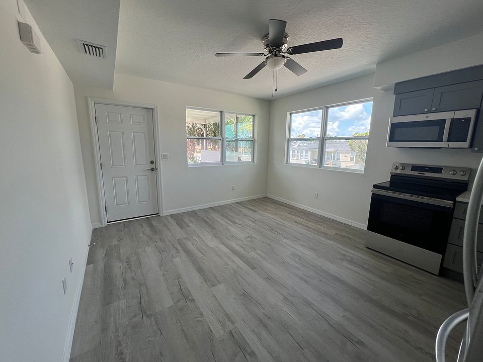 Living room with view to the kitchen and outside